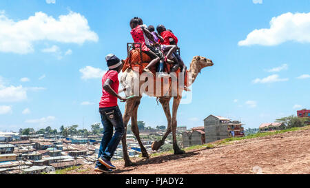 Nairobi, Kenya. 24th Mar, 2018. Local kids around Kibera Slums seen happily enjoying a free camel ride.Kibera is one of Africa's largest Slums located in East Africa, Kenya. Credit: Donwilson Odhiambo/SOPA Images/ZUMA Wire/Alamy Live News Stock Photo