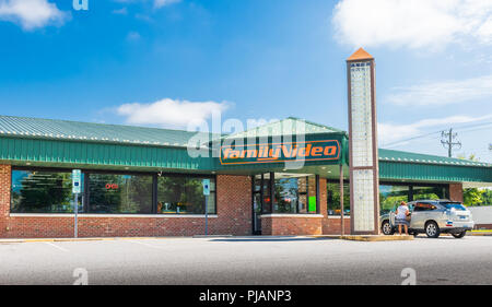HICKORY, NC, USA-9/2/18: A Family Video store, one in the only chain of video stores in the U.S. Shows one car and one female in parking lot. Stock Photo