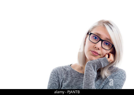 Sad pleading look of a young attractive woman isolated on white background. Tired and bored girl with hand under chin. Stock Photo