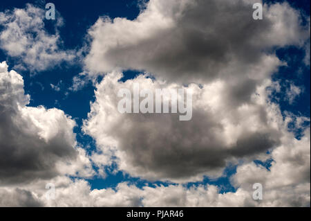 Cumulus fractious white puffy clouds with blue sky. Stock Photo