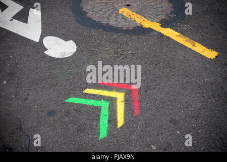 Red, yellow and green arrows painted on pavement Stock Photo