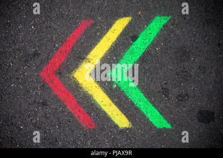 Red, yellow and green arrows painted on pavement Stock Photo