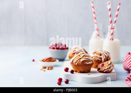 Muffins, cakes with cranberry and pecan nuts. Christmas decoration. Copy space.