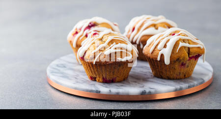 Muffins, cakes with cranberry and pecan nuts. Marble cutting board. Stock Photo
