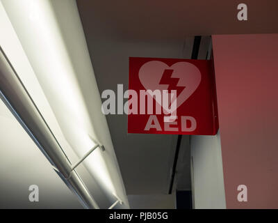 Automated external defibrillator AED logo hanging in public area Stock Photo