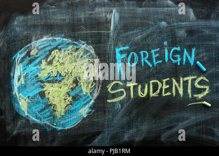 Foreign students exchange program concept with handwritten text in chalk on school blackboard Stock Photo