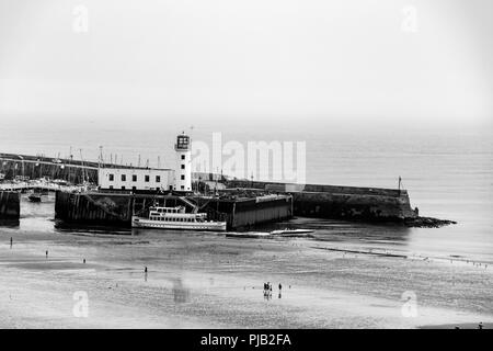 St. Vincent Pier and the historic lighthouse at Scarborough, North Yorkshire, UK. Stock Photo