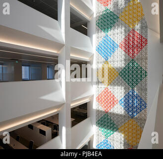 Atrium interior with artwork by Rasheed Araeen. Aga Khan Centre, London, United Kingdom. Architect: Maki and Associates, 2018. Stock Photo