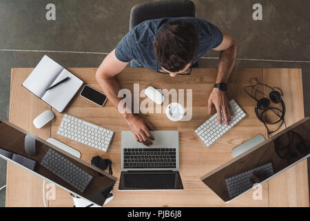 overhead view of programmer using computers at workplace Stock Photo