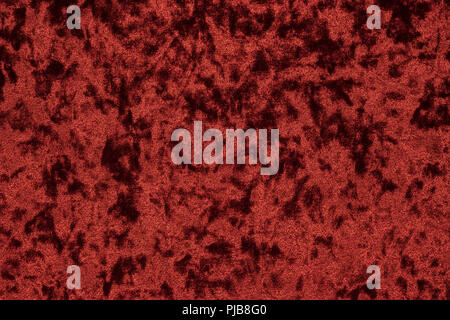 Highly detailed texture background of a red or wine color velour cloth characterized by its lush, plush surface composed of densely packed and closely Stock Photo