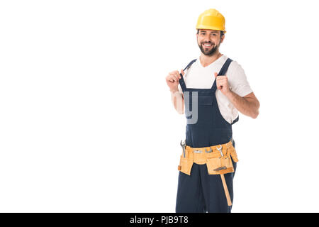 handsome happy workman in tool belt and hard hat smiling at camera isolated on white Stock Photo