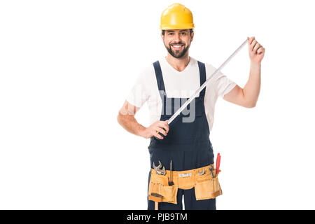 handsome happy workman holding measuring tape and smiling at camera isolated on white Stock Photo