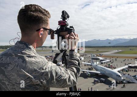 U.S. Air Force Airman 1st Class Richie Hayes, a broadcaster assigned to the 673d Air Base Wing Public Affairs, documents the Arctic Thunder Open House at Joint Base Elmendorf-Richardson, Alaska, July 1, 2018. This biennial event hosted by JBER is one of the largest in the state and one of the premier aerial demonstrations in the world. The event features multiple performers and ground acts to include the JBER joint forces, U.S. Air Force F-22 and U.S. Air Force Thunderbirds demonstrations teams, June 30-July 1. Stock Photo