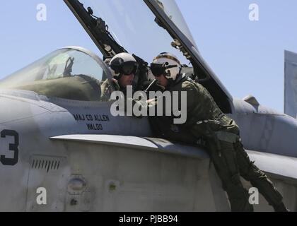 Maj. Gen. Mark R. Wise, commanding general for 3rd Marine Aircraft Wing, speaks with Lt. Col. Erik A. Peterson, commanding officer for Marine Fighter Attack Squadron (VMFA) 323, Marine Aircraft Group (MAG) 11, 3rd MAW, before his final flight at Marine Corps Air Station Miramar, San Diego Calif., July 02, 2018. Maj. Gen. Wise flew for the last time as the commanding general of 3rd MAW. Stock Photo