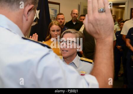 Rear Adm. Joanna Nunan, the Ninth District Commander, is administered the oath by retired Rear Adm. Mike Parks, former Ninth District Commander July 3, 2018 in Cleveland. Nunan was promoted from Rear Adm. Lower Half to Rear Adm. Upper Half. Stock Photo