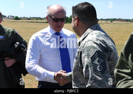 U.S. Ambassador to the U.K. Robert Wood Johnson shakes hands with Chief Master Sgt. Ernesto J. Rendon, 48th Fighter Wing command chief master sergeant, at RAF Lakenheath, England, July 2, 2018. Johnson toured various locations around the Liberty Wing including the 48th Medical Group and the 48th Operation Support Squadron to gain a better understanding of the wing’s mission and operations. Stock Photo