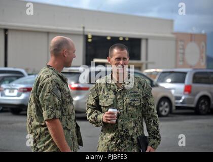 MARINE CORPS BASE HAWAII (July 11, 2018) — Rear Adm. John Okon, Commander, Naval Meteorology and Oceanography (METOC) Command, speaks with Chief Aerographer's Mate Steven Steinbeck, Commander, Task Force 172 deputy staff METOC officer, during a tour of Tactical Operations Center, Marine Corps Base Hawaii during Rim of the Pacific (RIMPAC) exercise, July 11. Twenty-five nations, 49 ships, six submarines, about 200 aircraft, and 25,000 personnel are participating in RIMPAC from June 27 to Aug. 2 in and around the Hawaiian Islands and Southern California. The world’s largest international maritim Stock Photo