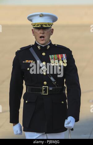Major Russell Fluker, parade adjutant, Marine Barracks Washington D.C., calls a command during a Tuesday Sunset Parade at the Lincoln Memorial, Washington D.C., July 10, 2018. The guest of honor for the parade was the former Vice President of the U.S., Joe Biden, and the hosting official was the Staff Judge Advocate to the Commandant of the Marine Corps, Maj. Gen. John R. Ewers Jr.