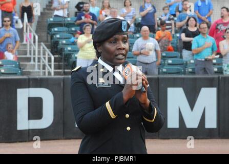 1st Lt. Shavon Holman sings the Star Spangled Banner at the Aberdeen Ironbirds baseball game on July 3. Soldiers from the 20th CBRNE Command represented the Army and Aberdeen Proving Ground at several community events July 1-4. Stock Photo