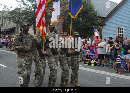 The 20th CBRNE Command Honor Guard marches along Main Street in Bel Air, Maryland, during the July 4th parade. Stock Photo