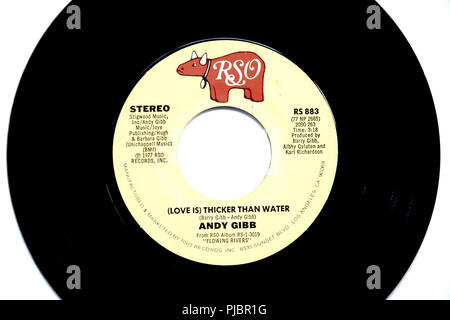 Close-up of 45 RPM vinyl record of Andy Gibb's song '(Love is) Thicker than Water' released in 1977 by RSO Records. Stock Photo
