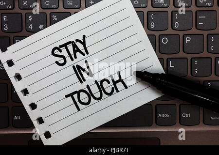 Text sign showing Stay In Touch. Conceptual photo Keep Connected thru Phone Letters Visit Email Social Media Notebook piece paper keyboard Inspiration Stock Photo