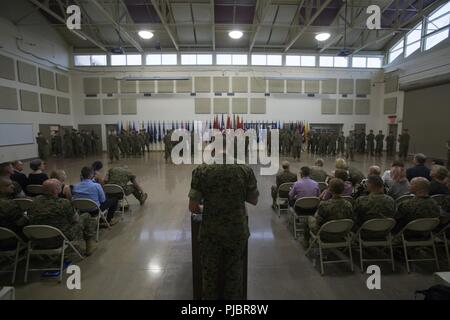 Marines, distinguished guests and visitors take their seats prior to a Change of Command ceremony at the Combat Logistics Regiment 4 headquarters in Kansas City, Mo., July 14, 2018. Change of Command ceremonies mark the passage of command from one Marine to another, symbolizing the transfer of responsibilities of his or her command position. And, as such, authorities and responsibilities of 4th Marine Logistics Group were formally passed from Maj. Gen. Helen Pratt to Brig. Gen. Karl Pierson. Stock Photo