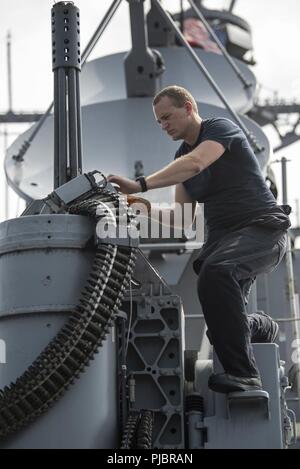 A Fire Controlman 1st Class provides instruction on the Phalanx Close ...