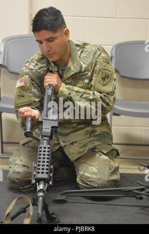 A U.S. Army Reserve Troop List Unit Soldier clears an M240B machine gun while participating in preliminary marksmanship instruction during Operation Cold Steel II, July 9, 2018 at Joint Base McGuire-Dix-Lakehurst, N.J. Operation Cold Steel is the U.S. Army Reserve’s crew-served weapons qualification and validation exercise to ensure America’s Army Reserve units and Soldiers are trained and ready to deploy on short notice as part of Ready Force X and bring combat-ready and lethal firepower in support of the Army and our joint partners anywhere in the world. Stock Photo