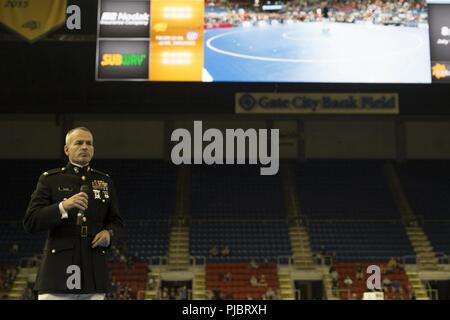 Col. David Fallon, commanding officer of 9th MCD, compares Marines and wrestlers during the 2018 U.S. Marine Corps Freestyle Finals in Fargo, North Dakota, July 15. The Freestyle Finals feature more than 30 top-level athletes from across the country. Wrestlers share many of the same values as those exhibited by Marines, so the Marine Corps Recruiting Command developed a national-level wrestling marketing relationship to engage the USMC’s target audience and their influencers. Stock Photo