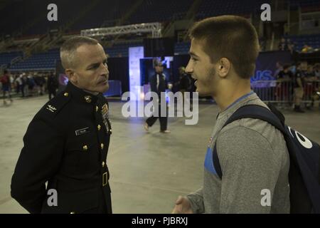 Col. David Fallon, commanding officer of 9th MCD, discusses wrestling with Sam Frankowski, a wrestler from Rockwood Summit High School in Fenton, Missouri during the 2018 U.S. Marine Corps Freestyle Finals in Fargo, North Dakota, July 15. The Freestyle Finals feature more than 30 top-level athletes from across the country. Wrestlers share many of the same values as those exhibited by Marines, so the Marine Corps Recruiting Command developed a national-level wrestling marketing relationship to engage the USMC’s target audience and their influencers. Stock Photo