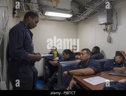 SEA (July 12, 2018) Navy Counselor 1st Class Timothy Sinclair gives career counselor training aboard the Harpers Ferry-class dock landing ship USS Oak Hill (LSD 51) July 12, 2018. Oak Hill, homeported in Virginia Beach, Virginia, is conducting naval operations in the U.S. 6th Fleet area of operations in support of U.S. national security interests in Europe and Africa. Stock Photo