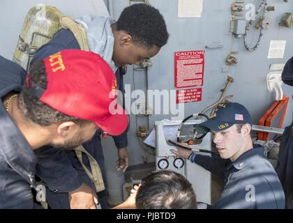 NORTH SEA (July 12, 2018) Damage Controlman 3rd Class Jake Spille gives damage control training during damage control team training aboard the Harpers Ferry-class dock landing ship USS Oak Hill (LSD 51) July 12, 2018. Oak Hill, home-ported in Virginia Beach, Virginia, is conducting naval operations in the U.S. 6th Fleet area of operations. Stock Photo