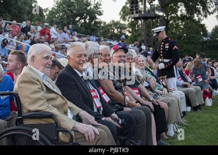 Guests with the World War II Marine Raiders smile for a photo before a Friday Evening Parade at Marine Barracks Washington D.C., July 13, 2018. The guest of honor for the parade was the U.S. Senator for Wisconsin, Ron Johnson, and the hosting official was the Commandant of the Marine Corps, Gen. Robert B. Neller. Stock Photo