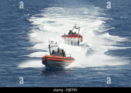 PACIFIC OCEAN (July 15, 2018) Coast Guard Tactical Delivery Team members assigned to Maritime Security Response Team-West (MSRT) perform an approach on the U.S. Coast Guard Cutter Bertholf (WMSL 750) July 15, in support of the Rim of the Pacific (RIMPAC) exercise. Twenty-five nations, 46 ships and five submarines, about 200 aircraft and 25,000 personnel are participating in RIMPAC from June 27 to Aug. 2 in and around the Hawaiian Island and Southern California.  The world’s largest international maritime exercise, RIMPAC provides a unique training opportunity while fostering and sustaining coo Stock Photo