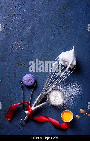 Baking or cooking background. Ingredients, kitchen items for baking cakes. Kitchen utensils, flour, eggs, macaroni dessert. New year, top view. Stock Photo