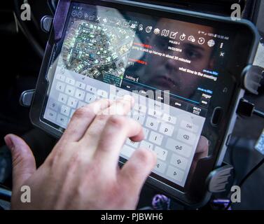 A 96th Security Forces Squadron uses the android tactical assault kit to send a message from his patrol vehicle July 5 at Eglin Air Force Base, Fla.  The ATAK is a new communication system implemented at Eglin that so far has provided significant improvements in the base’s defense mission.  The tablet-based system provides written communication, pictures, mapping, GPS and data access to defenders more quickly than previous methods which relied heavily on radio transmissions. Stock Photo