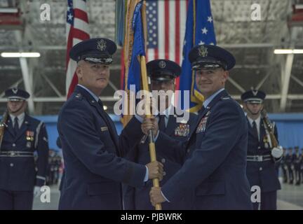 Maj. Gen. James A. Jacobson, left, commander of the Air Force District of Washington and the 320th Air Expeditionary Wing, presents Col. Andrew M. Purath with the 11th Wing guidon in a change of command ceremony on Joint Base Andrews, Md., July 10, 2018. Purath was previously the vice commander of the 386th Air Expeditionary Wing, Southwest Asia. Stock Photo