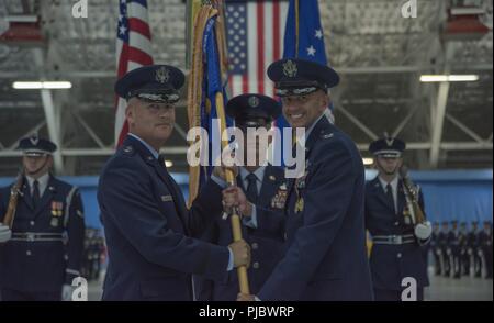 Maj. Gen. James A. Jacobson, left, commander of the Air Force District of Washington and the 320th Air Expeditionary Wing, receives the 11th Wing guidon from Col. E. John Teichert in a change of command ceremony on Joint Base Andrews on JBA, Md., July 10, 2018. Teichert will soon assume command at the 412th Test Wing on Edwards Air Force Base, Calif. Stock Photo