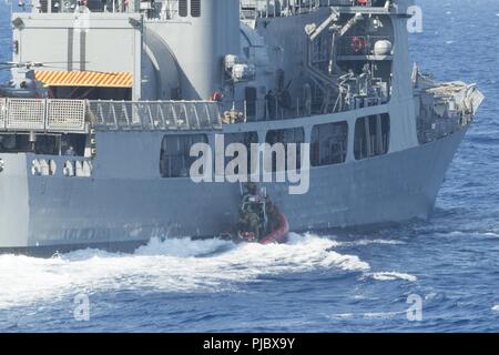 PACIFIC OCEAN (July 16, 2018) A Coast Guard Tactical Delivery Team (TDT) perform a hook and climb operation to board the Philippine Navy frigate BRP Andrés Bonifacio (FF 17) during a training operation as part of Rim of the Pacific (RIMAPC) exercise, July 16. TDT members are part of the Coast Guard's Maritime Security Response Team-West, and routinely train to board compliant and non-compliant vessels. Twenty-five nations, 46 ships, five submarines, about 200 aircraft and 25,000 personnel are participating in RIMPAC from June 27 to Aug. 2 in and around the Hawaiian Islands and Southern Califor Stock Photo