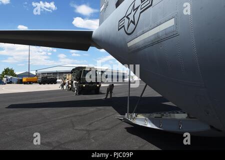 Airmen from the 173rd Fighter Wing prepare to load equipment on a C-130J Super Hercules from Little Rock Air Force Base, Ark. as part of the joint Cascadia Airlift Exercise July 14, 2018 at Kingsley Field in Klamath Falls, Oregon. Airmen from Little Rock and the 173rd FW teamed up to prepare to respond to a potential large-scale earthquake off the coast of Oregon. The Oregon National Guard’s mission is to be “a ready force equipped and trained to respond to any contingency,” and disaster relief efforts play a central role in that mission. Stock Photo