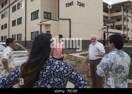 MARINE CORPS BASE HAWAII (July 18, 2018) David Tripp, second from left, director of unaccompanied personal housing, Marine Corps Base Hawaii (MCBH), provides staff delegates from the offices of U.S. Reps. Colleen Hanabusa (D-HI) and Tulsi Gabbard (D-HI), a tour of barracks on MCBH July 14, 2018. The visit was to provide an opportunity for various staff delegates from the offices of State Representatives to experience Rim of Pacific (RIMPAC) exercise and participate in tours and meetings to extend their knowledge of Navy and Marine Corps equities around the island. RIMPAC provides high-value tr Stock Photo