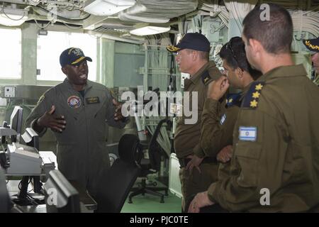 PEARL HARBOR, Hawaii (July 18, 2018) Rear Adm. Cedric Pringle, commander, Expeditionary Strike Group (ESG) 3, left, speaks to Israeli Navy Rear Adm. Ido Ben-Moshe, center left, head of naval operations, and his staff as part of a tour of the amphibious assault ship USS Bonhomme Richard (LHD 6), during the Rim of the Pacific (RIMPAC) 2018 exercise. Twenty-five nations, 46 ships, five submarines, about 200 aircraft and 25,000 personnel are participating in RIMPAC from June 27 to Aug. 2 in and around the Hawaiian Islands and Southern California. The world’s largest international maritime exercise Stock Photo