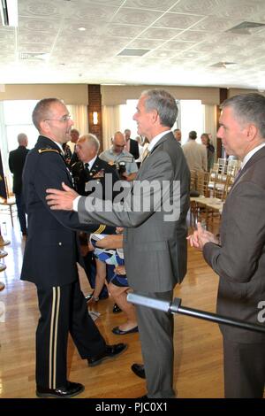 Deputy Assistant Secretary of the Army for Civil Works David Leach (center) congratulates out-going commander Maj. Gen. William H. Graham at the conclusion of the U.S. Army Corps of Engineers North Atlantic Division change-of-command ceremony at the Fort Hamilton Community Club in Brooklyn, New York on July 19, 2018. Leach is a former member of the New York District based in Manhattan and the North Atlantic Division. Stock Photo