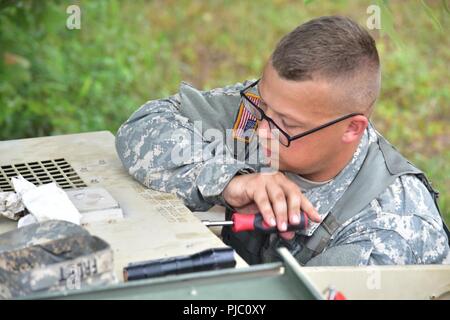 In this image, released by the U.S. Army Reserve, Soldiers with the 420th Engineer Brigade conduct equipment repair during River Assault 2018 at Fort Chaffee, Arkansas, July 18, 2018. The exercise stresses the warrior and engineer skills of the troops as they engage two weeks of training in weapons familiarity, security, and wet gap crossing in a tactical environment. Stock Photo