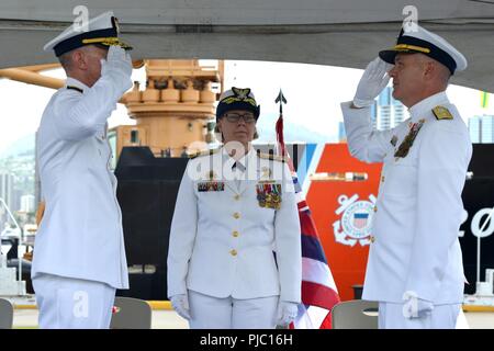 Rear Adm. Kevin E. Lunday (left) relieves Rear Adm. Brian K. Penoyer (right) as commander of the Fourteenth Coast Guard District while Vice Adm. Linda L. Fagan (center) presides during a change of command ceremony at Coast Guard Base Honolulu, July 19, 2018.  Lunday was previously commander of Coast Guard Cyber Command.