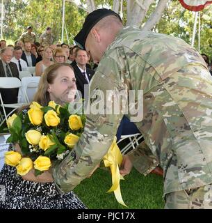 Melissa Barta, wife of Col. Aaron Barta, incoming U.S. Army Corps of Engineers Los Angeles District commander, left, receives flowers during a July 19 change of command ceremony at Fort MacArthur in San Pedro, California. Stock Photo