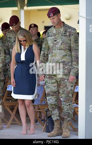 U.S. Army Col James B. Bartholomees III, commander of the 173rd Airborne Brigade, and his wife bow their heads for an invocation during the change of responsibility ceremony at Caserma Ederle in Vicenza, Italy, July 19, 2018. The 173rd Airborne Brigade is the U.S. Army Contingency Response Force in Europe, capable of projecting ready forces anywhere in the U.S. European, Africa or Central Commands' areas of responsibility. Stock Photo