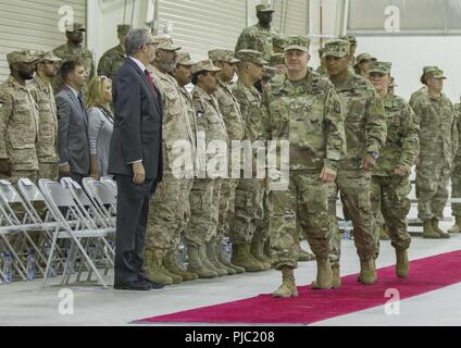 Outgoing 335th Signal Command (Theater) (Provisional) commander U.S. Army Brig. Gen. John H. Phillips, U.S. Army Central’s commanding general U.S. Army Lt. Gen. Michael X. Garrett, and incoming 335th SC (T) (P) commander U.S. Army Brig. Gen. Nikki L. Griffin Olive enter the 335th SC (T) (P)  change of command ceremony at Camp Arifjan, Kuwait, July 19, 2018. The 335th SC (T) (P) is headquartered in Camp Arifjan and provides communication services to coalition and joint forces located at over 30 sites in 11 countries throughout Southwest Asia. Stock Photo