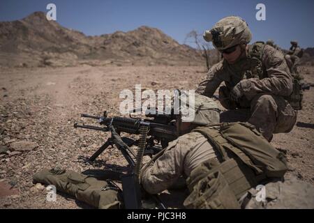 CAMP TITIN, Jordan (July 8, 2018) U.S. Marines assigned to Battalion Landing Team, 2nd Battalion, 6th Marine Regiment (BLT 2/6), 26th Marine Expeditionary Unit (MEU), conduct a machine gun course-of-fire during sustainment training at Camp Titin, Jordan, July 8, 2018. Iwo Jima is the flagship for the Iwo Jima Amphibious Ready Group and, with the embarked 26th Marine Expeditionary Unit, is deployed to the U.S. 5th Fleet area of operations in support of naval operations to ensure maritime stability and security in the Central region, connecting the Mediterranean and the Pacific through the weste Stock Photo